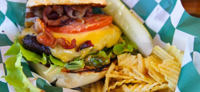 Delicious burger with melted cheese, tomatoes and lettuce.