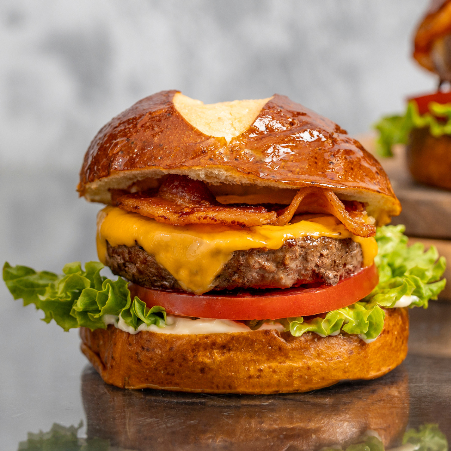 bacon cheeseburger topped with lettuce, tomato, bacon, and cheese
