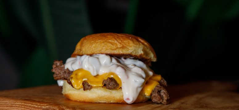 Ground beef smothered in cheese between two buns.