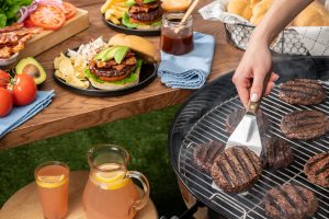 Grilling burgers and picnic table set for a bbq