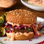 Burger topped with sauce and slaw.