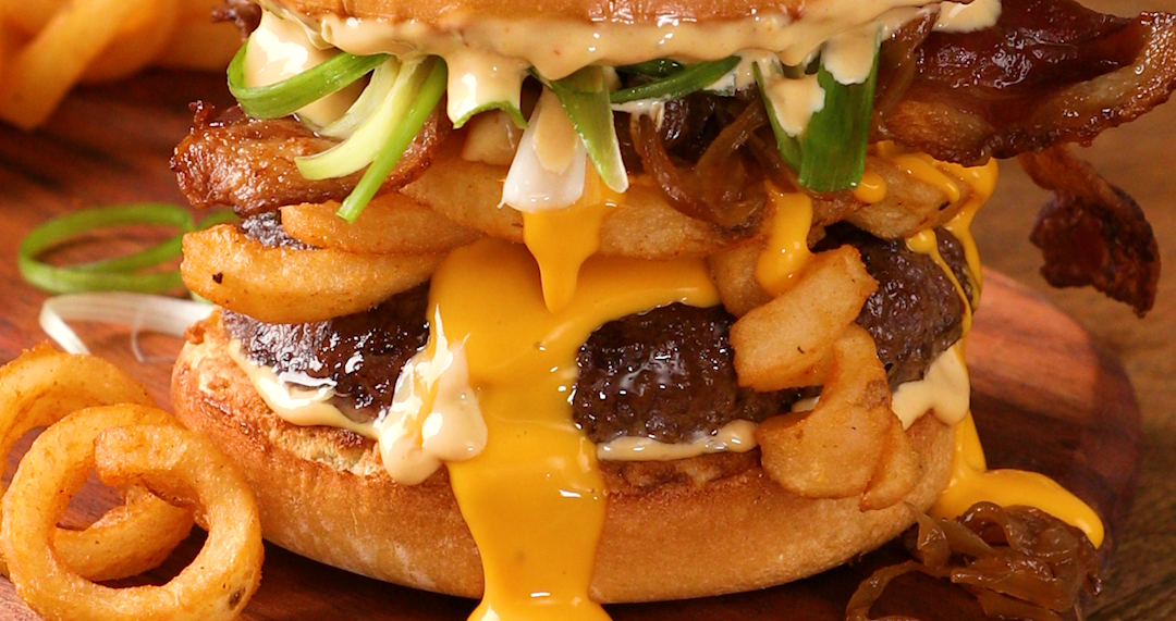 Burger with cheese dripping with cheese and French Fries.