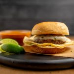 Birria Inspired Burger is a Burger with a Tortilla and dipping sauce