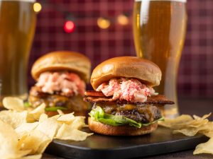 Burgers topped with lobster and bacon