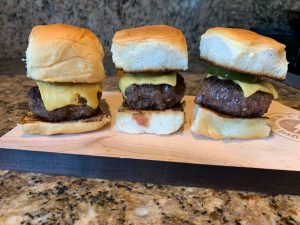 Schweid and Sons Signature Blend 2.5 oz sliders topped with cheese.