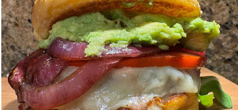 Giada De Laurentiis Game Day Burger with avocado, tomato, pickled onions, arugula, with toasted buns