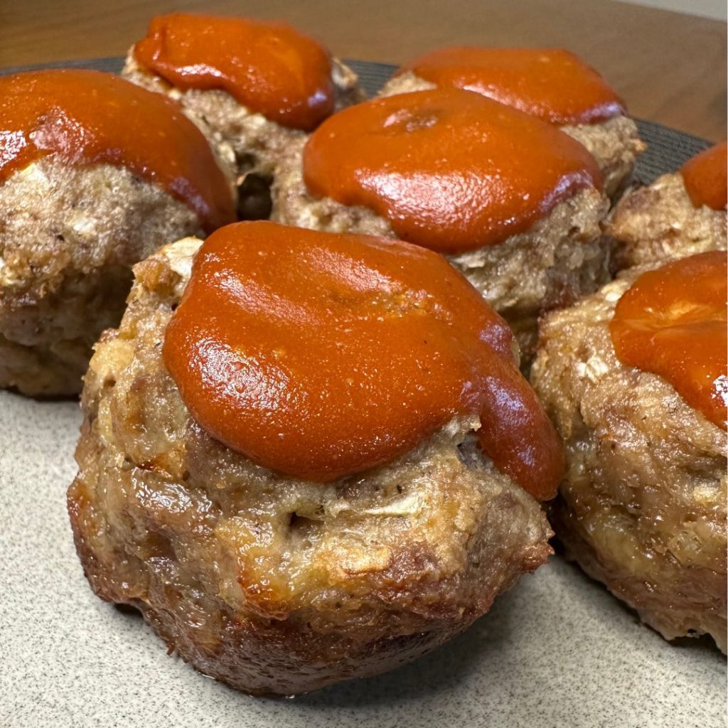 meatloaf muffins with schweid and sons beef, onions, garlic, milk, eggs and topped with a ketchup, mustard, and Worcestershire sauce