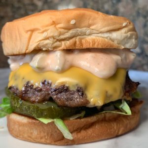Schweid & Sons Burger smothered with a special sauce