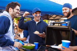tailgate with friends around the grill during the fall or winter