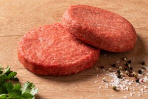 two raw burger patties with an 80/20 lean to fat ratio