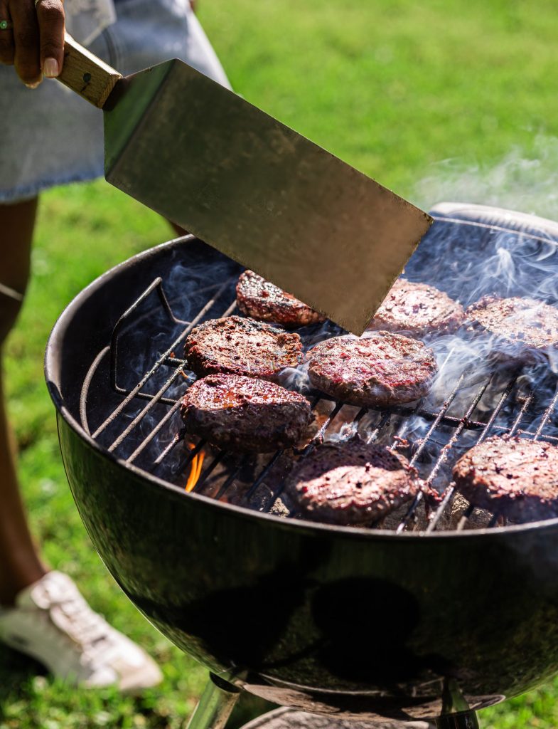 schweid and sons burgers being flipped on a grill