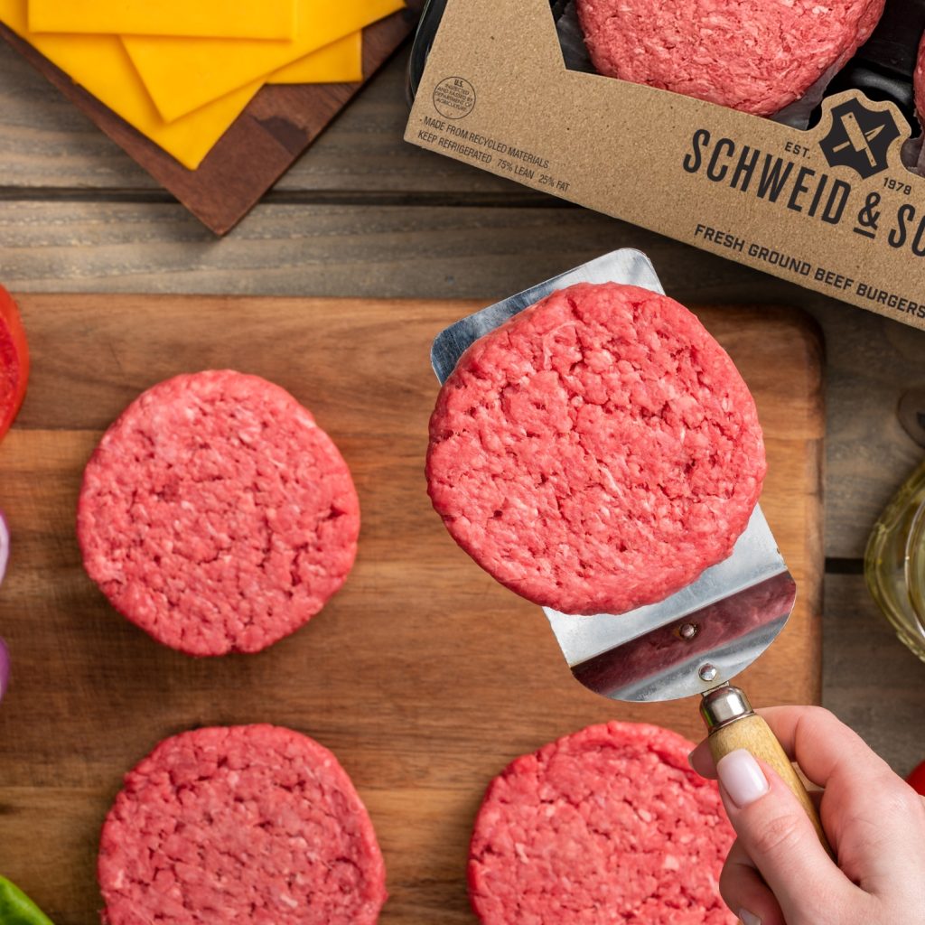 raw schweid and sons burgers on a wood board