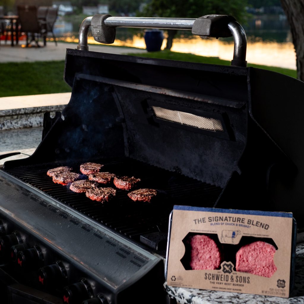 schweid and sons signature blend burgers cooking on a grill
