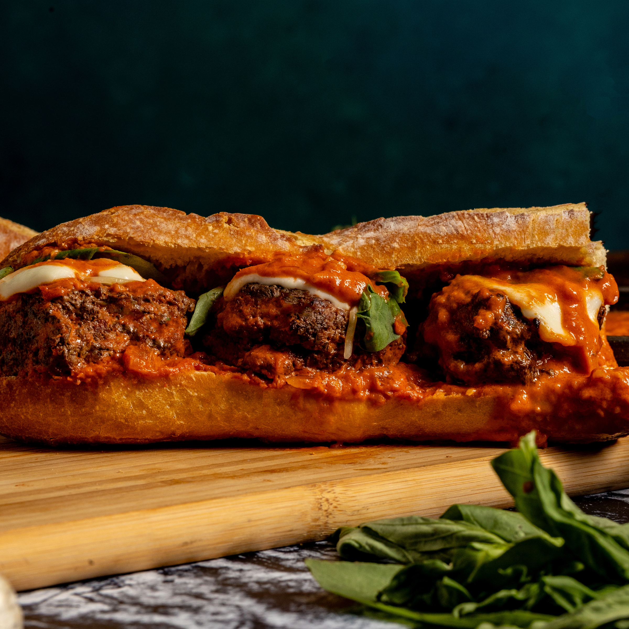 Spicy Vodka Parm Sliders Sub made with schweid and sons the signature blend sliders topped with homemade vodka sauce, mozzarella cheese, and basil